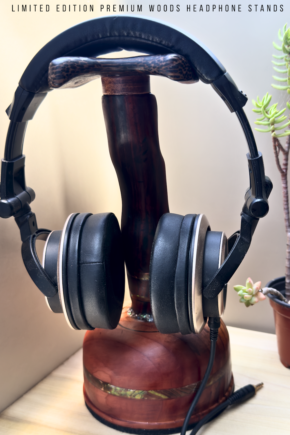 Cocobolo headphone stand displaying premium headphones