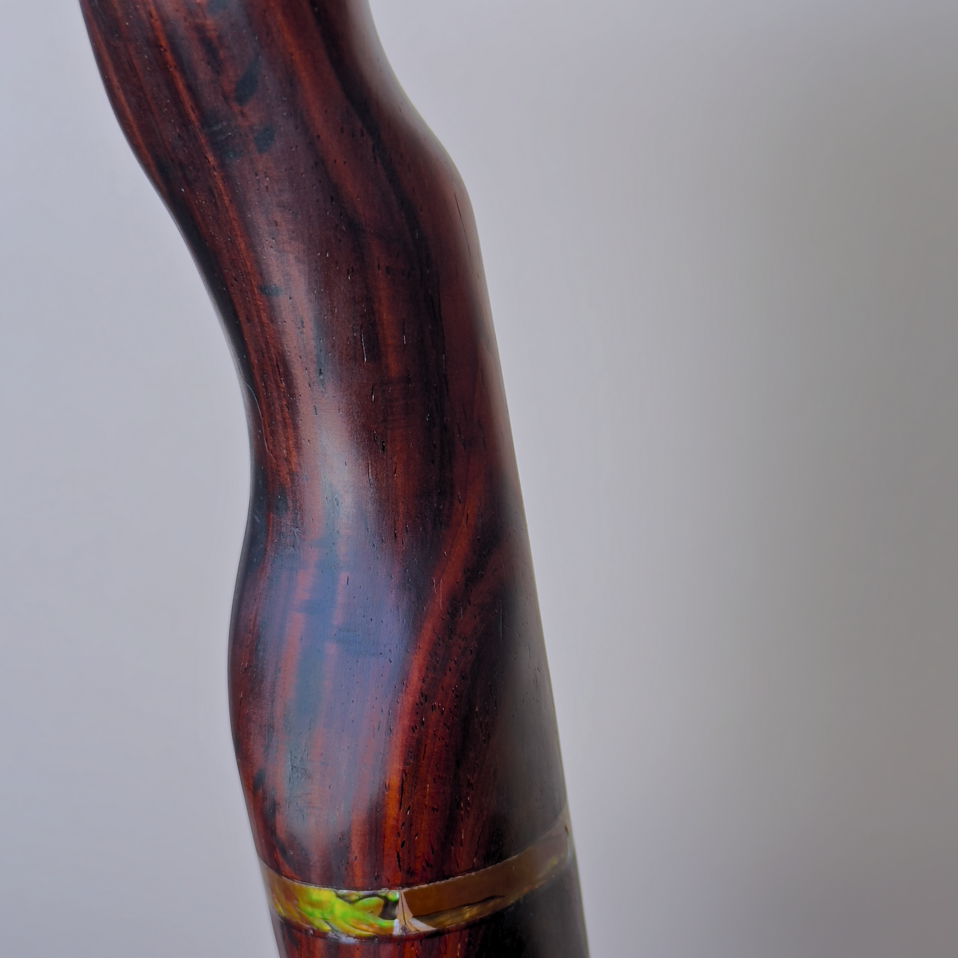 Cocobolo wood grain detail on handmade headphone stand