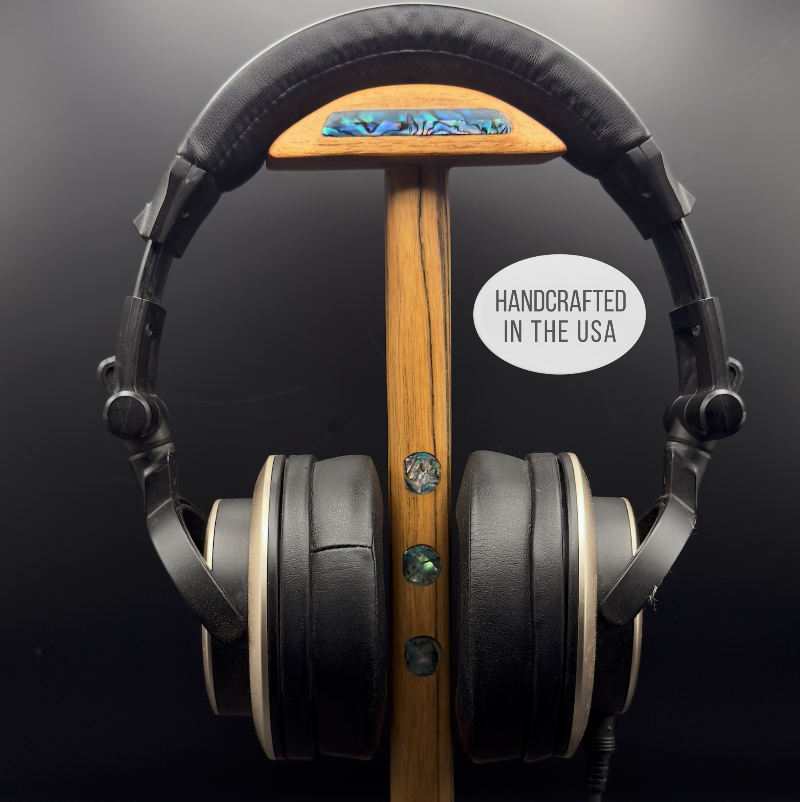 "Exotic wood headphone stand displaying audiophile headphones