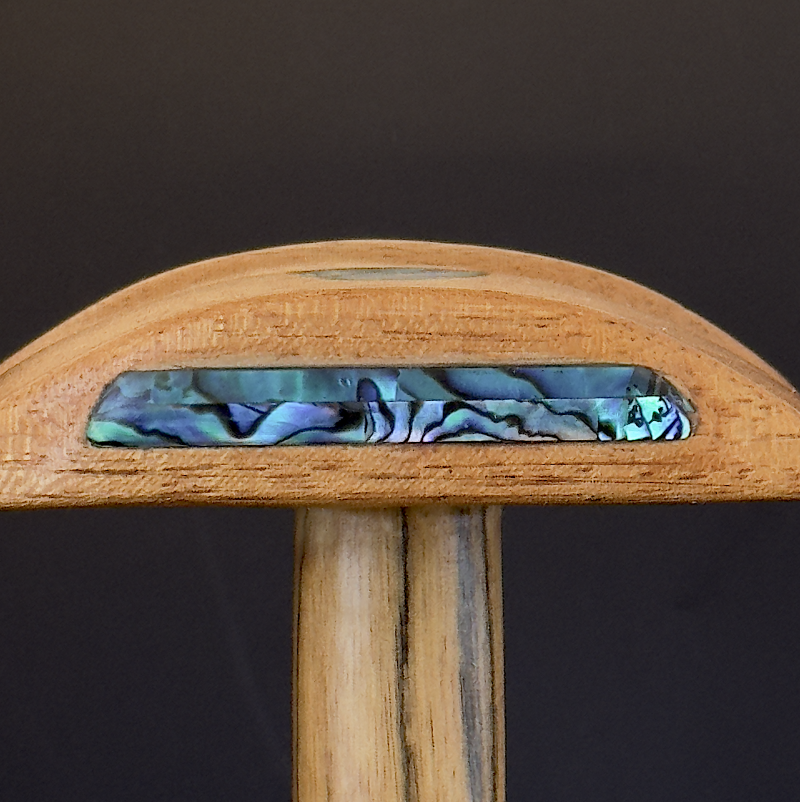 Close-up of abalone shell tribal pattern on headphone stand