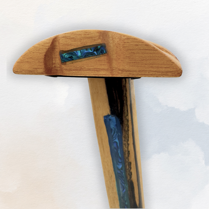 Close-up of abalone shell tribal design on rosewood stand