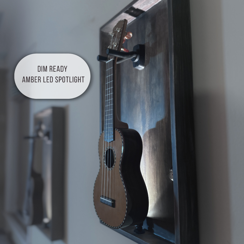 Ukulele displayed in a reflective surface with 'Dim Ready Amber LED Spotlight' text.