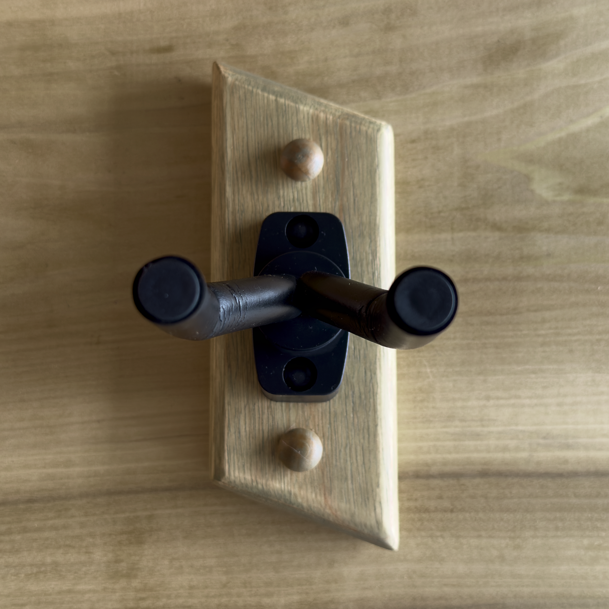 Detail of exotic wood inlay on handmade guitar wall mount