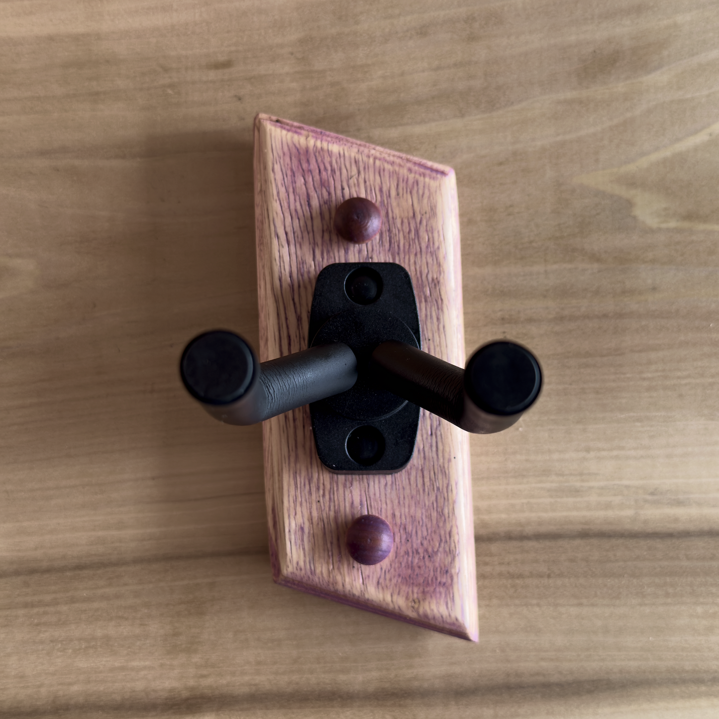 Detail of exotic wood inlay on handmade guitar wall mount